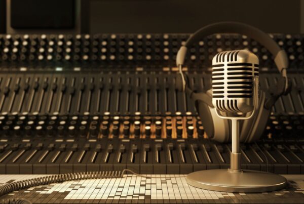 An old-fashioned radio control booth with a microphone and headset.